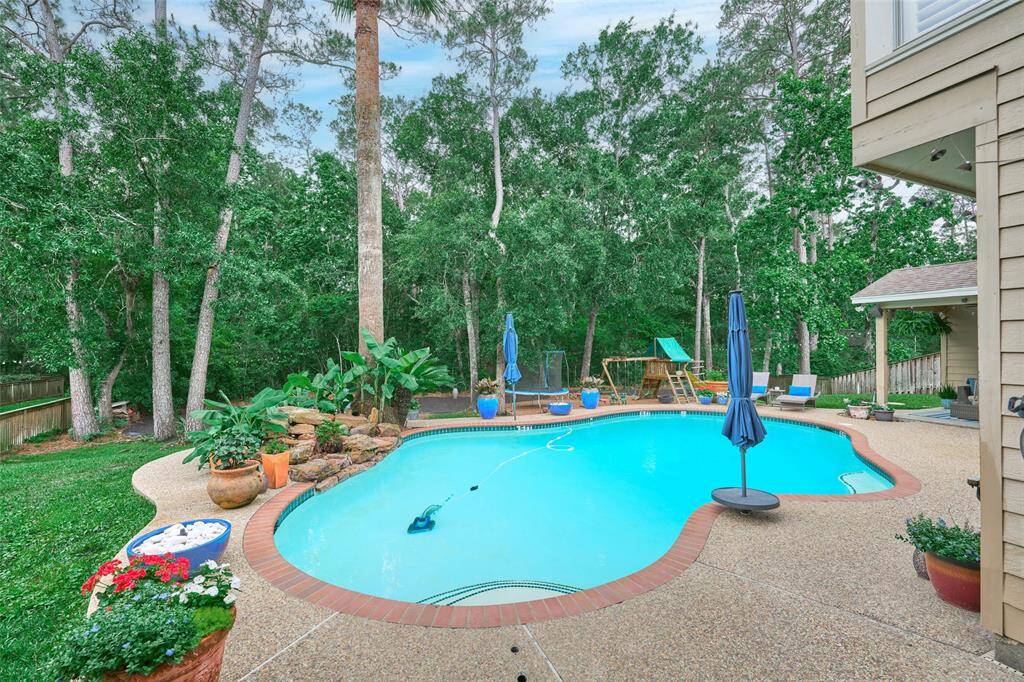 This yard has something for everyone! The kids can play while the adults relax around the cozy firepit.