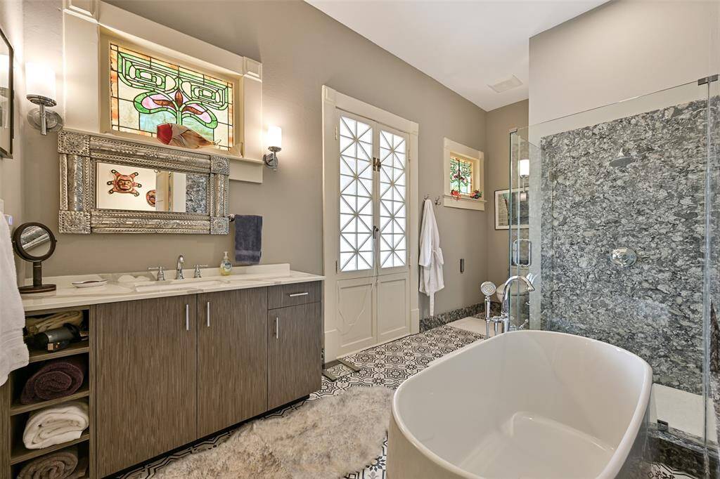 This Guest Bathroom has Both a Shower and a Luxurious Soaking Tub with Interesting High-End Finishes!
