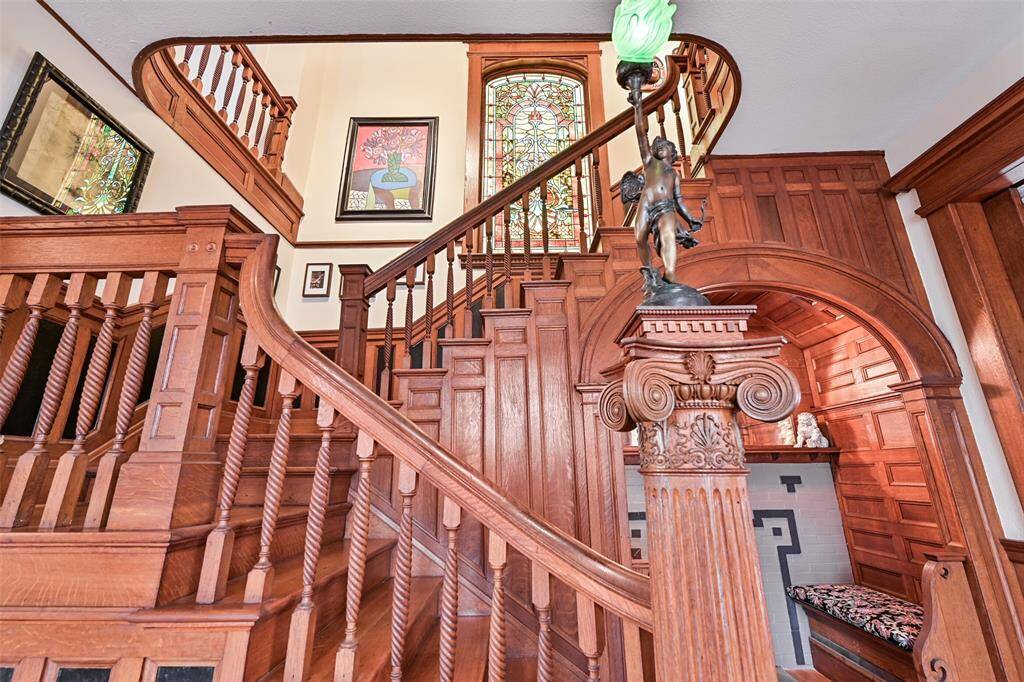 Gorgeous Natural Wood Staircase was Never Painted and Retains Its Original Patina. Note the Beautiful, Lit from Behind Stained-Glass Window at the Top of the Stairs!