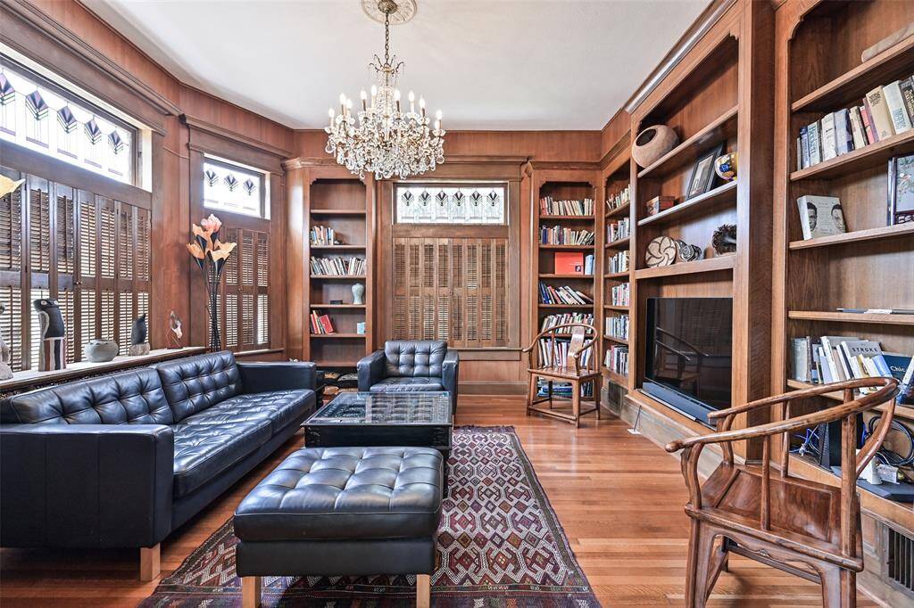 Upon Entering the Home, there is a Lovely Library Room with Warm Wood Paneling to the Left that could be either an Office or Den Area. Note the Chandelier and Its Mate, Located in the Formal Living Room Across the Foyer!