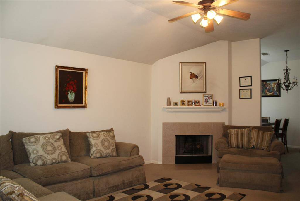 Another view of living room showing gas fireplace.