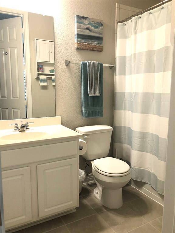 Bathroom with tile floor and on the left you will find a walking closet.