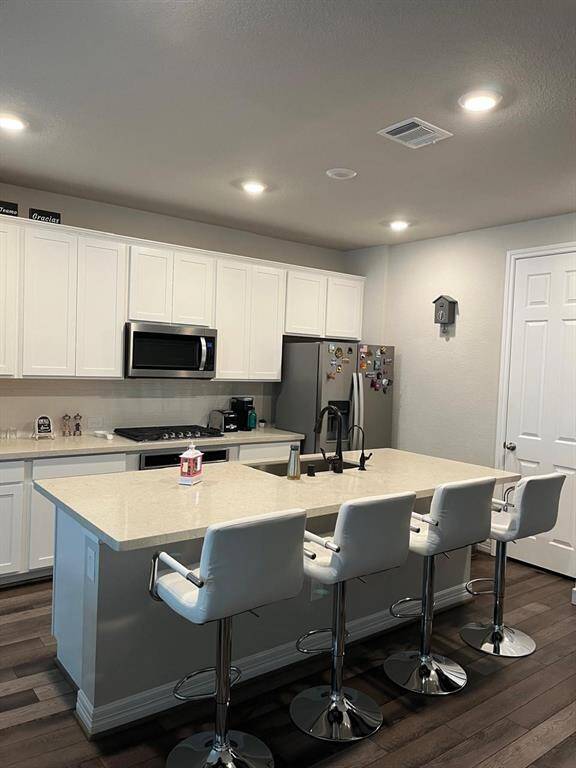 Kitchen with quartz countertops and plenty of space for 4 stools.