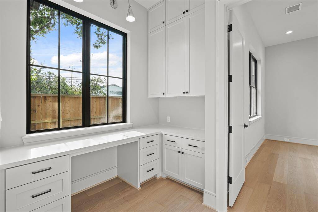 The secondary, mini-office gets a fantastic view of the sideyard!