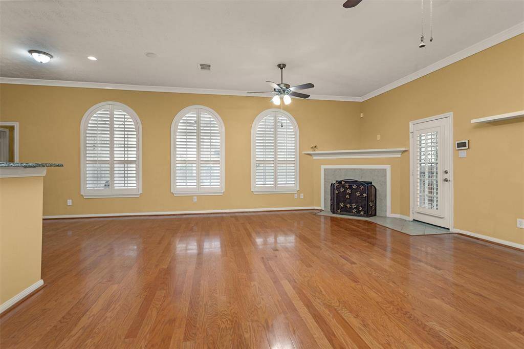 The spacious Family Room boasts beautiful arched windows looking out into the BackYard, filling the room with natural light!