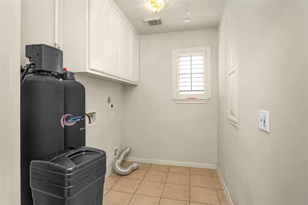 Large Laundry Room features built-in cabinets for storage!