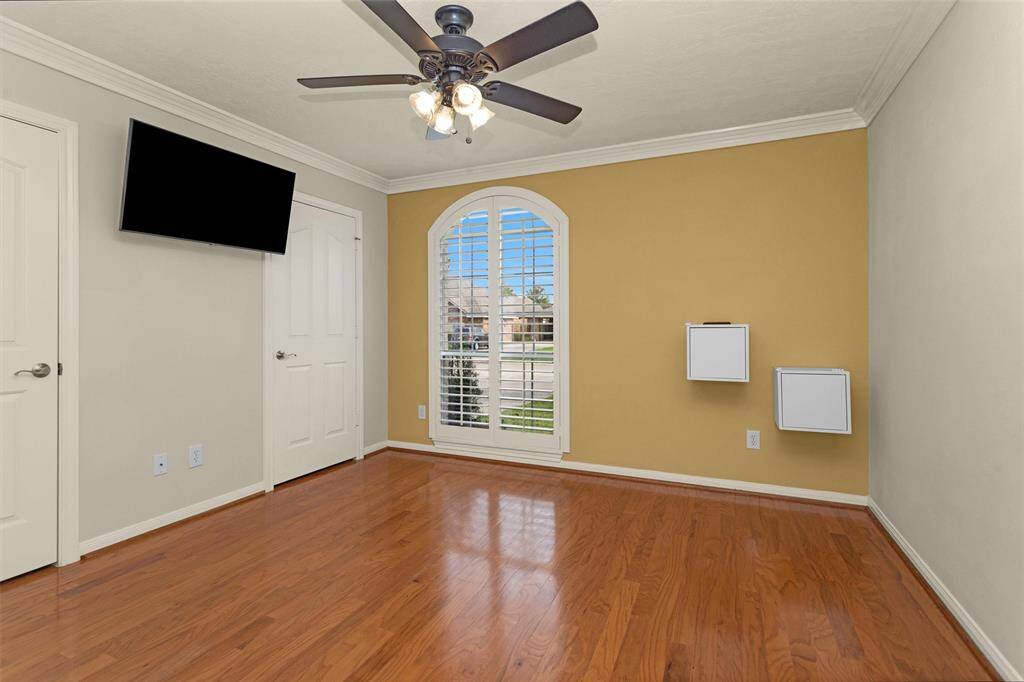 Bedroom #2 also features hardwood flooring, a ceiling fan, closet and beautiful arched window!