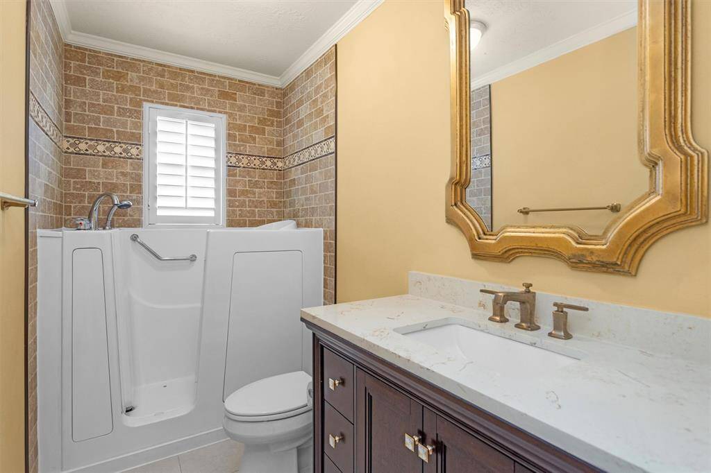 Updated Secondary Bathroom includes a Handicap-Accessible Walk-In Bath Tub.