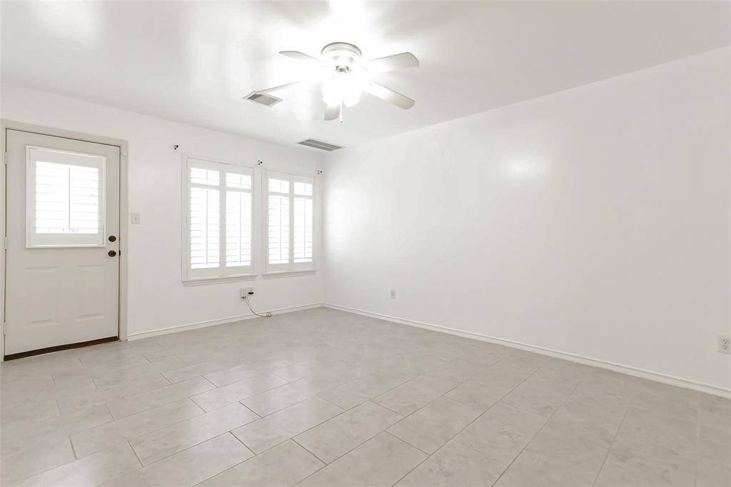 Another view of the first floor bedroom with door leading to backyard space