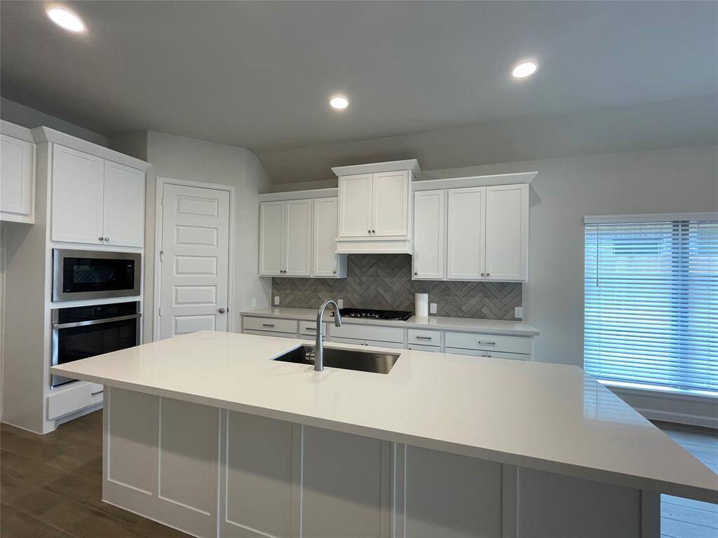 Island Sink in the kitchen and Plenty of cabinetry for all extra storage.