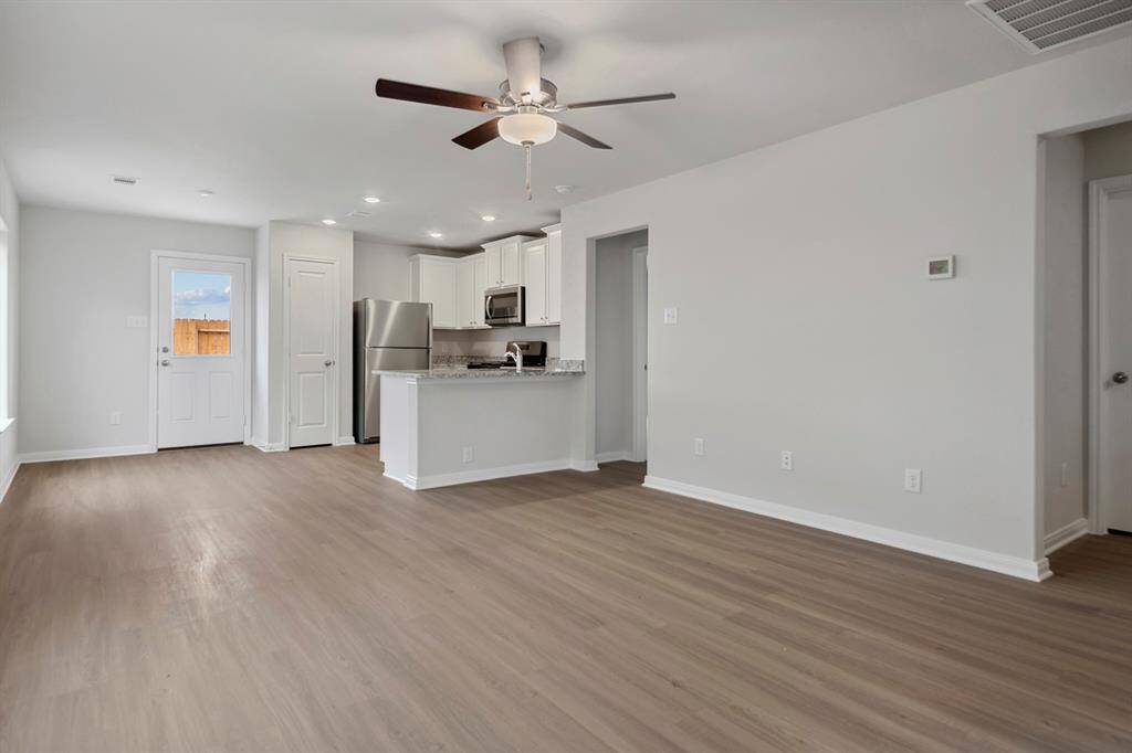 The kitchen is upgraded with Whirlpool appliances and granite countertops.