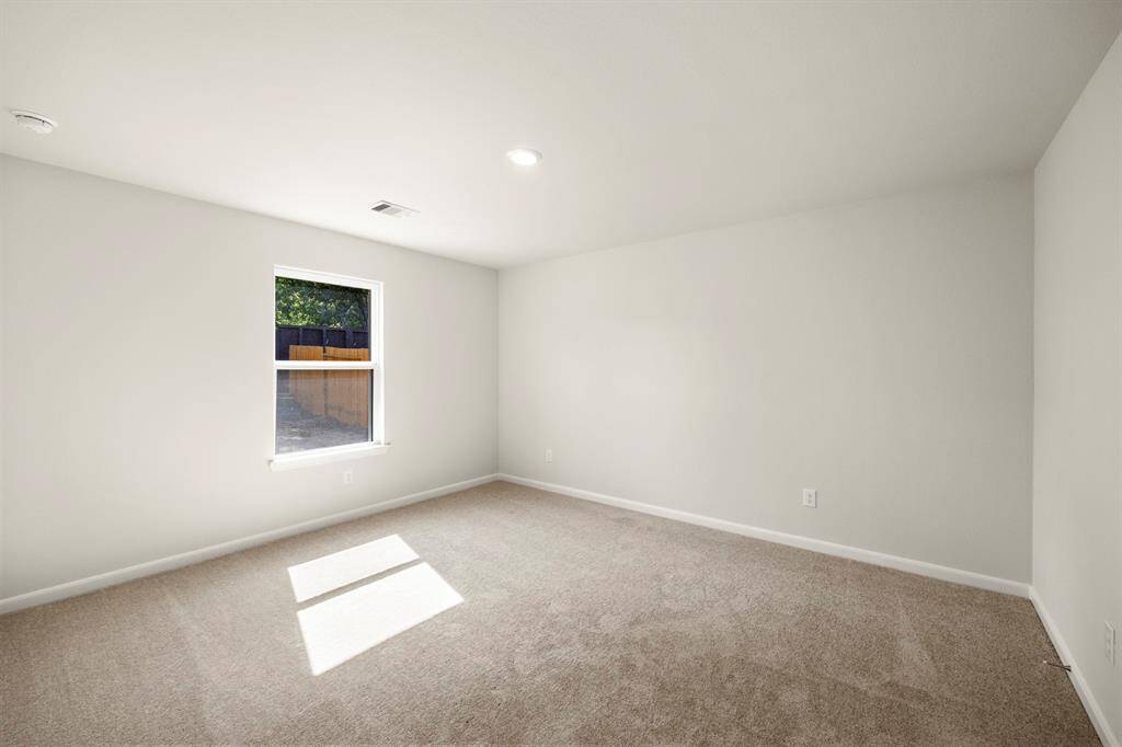 The primary bedroom is a great place to relax after a long day, and it’s large enough for the king-sized bed!