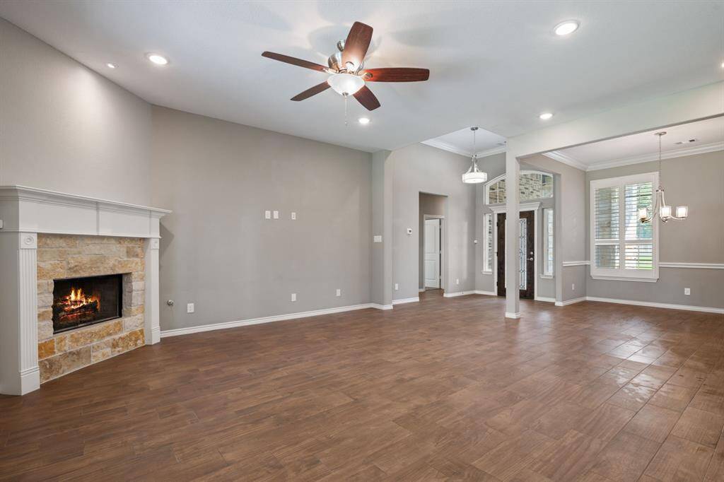 Spacious living area with cozy fireplace and clear sightlines to the elegant entry and formal dining.