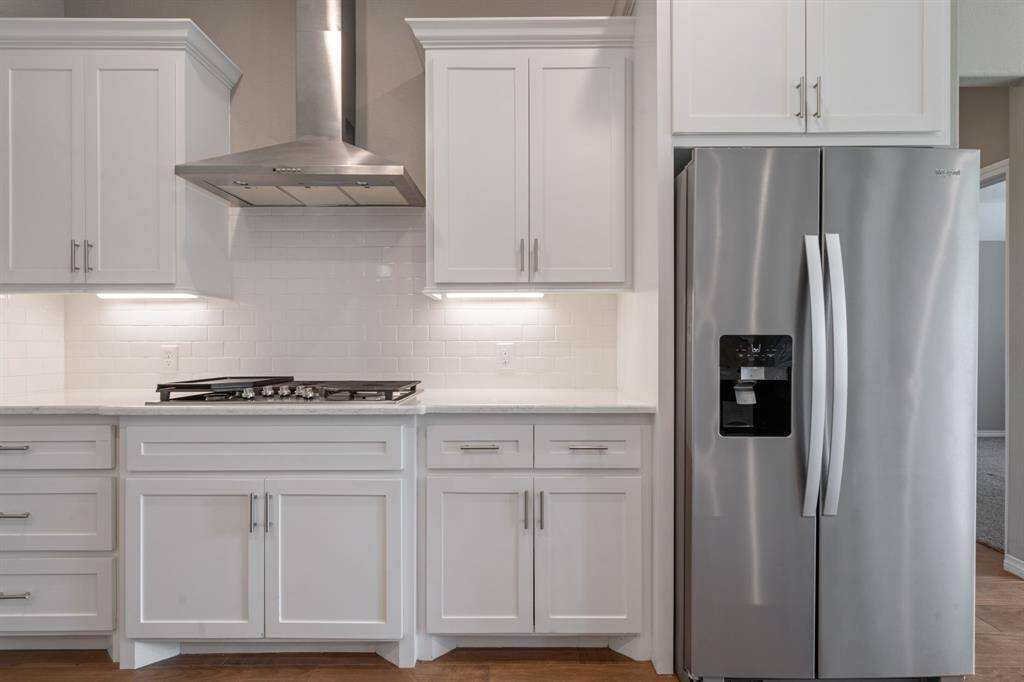 Sleek stainless steel appliances and generous cabinet storage make this kitchen as functional as it is stylish.