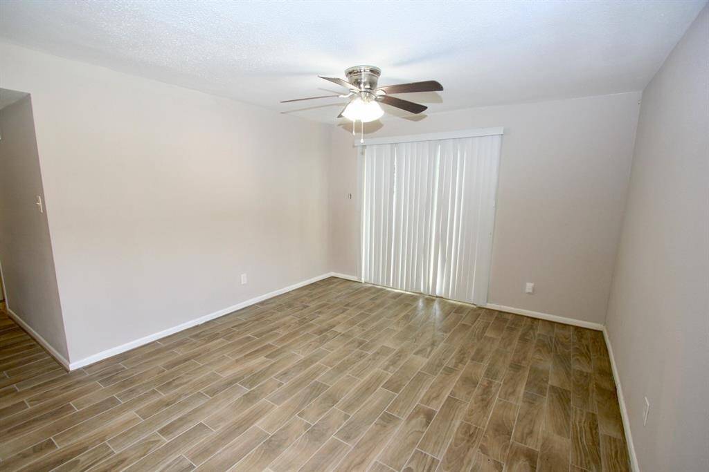 Living Area - nice and spacious. Sliding glass door into the patio area. New ceiling fan.