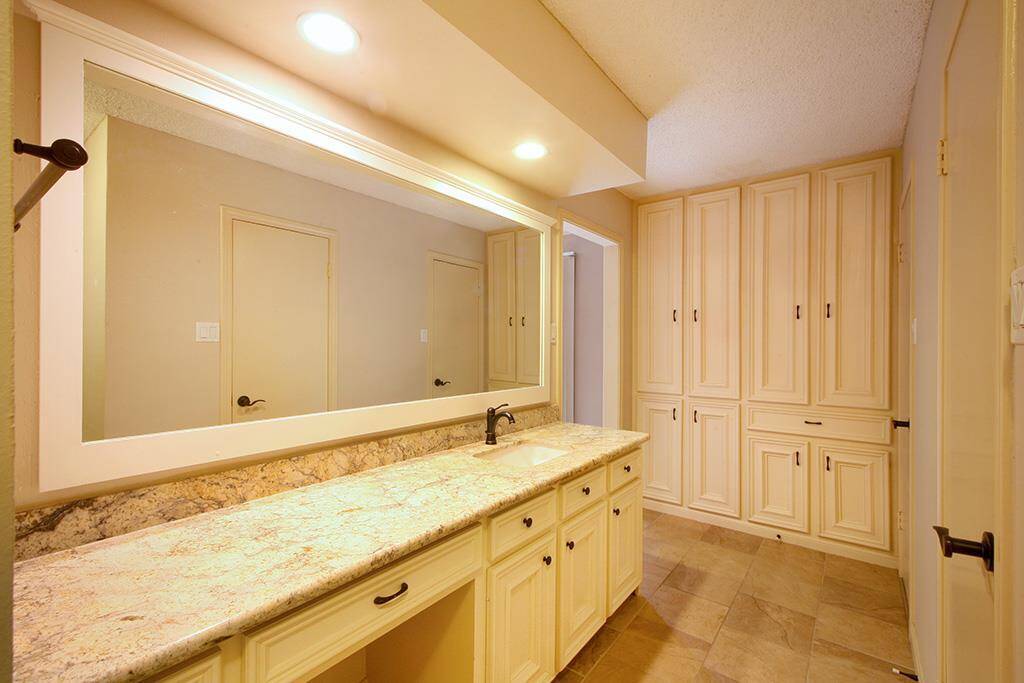 Too many cabinets to get in pictures. You have storage! Two walk-in closets and designer hardware. Walk out of your master through French doors on to private brick paved, landscaped yard and gorgeous patio.