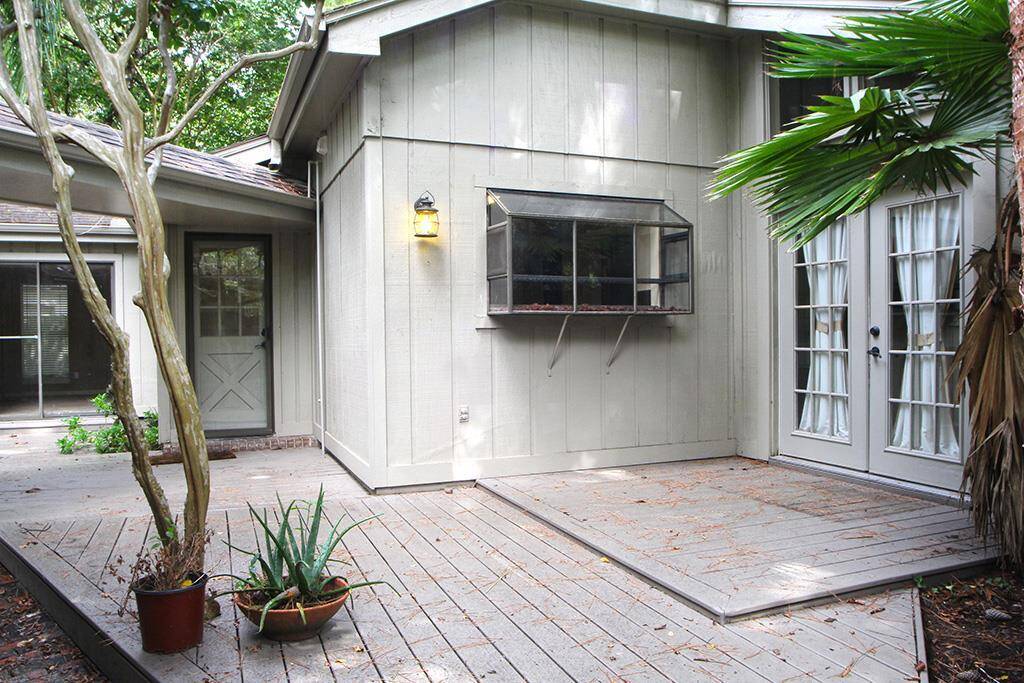 What a joy to come home to. Covered walkway from garage or driveway, two sets of French doors and glass screened door to kitchen. Look at the tiered new decking! You ll want to spend more time at home!
