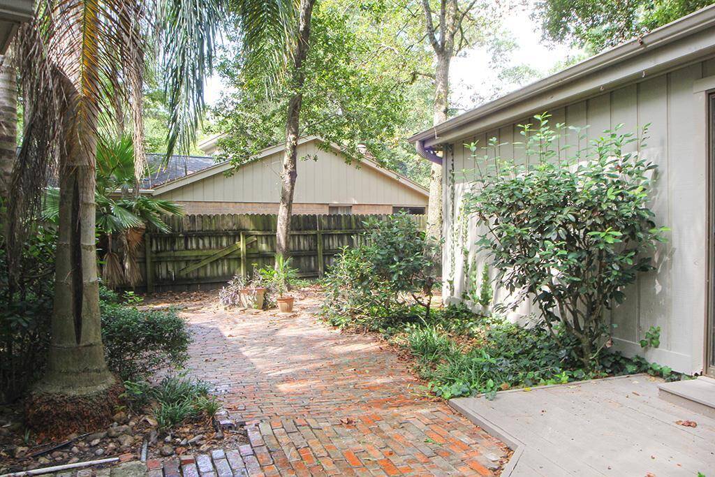 Hand paved brick patio with cury linear design. This adds value, beauty and low maintenance to an elegant home in popular Grogans  Mill.
