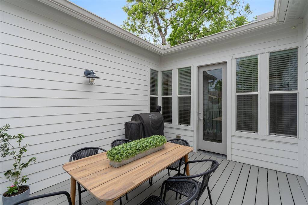 This private deck retreat offers a tranquil spot for entertaining or everyday outdoor meals, conveniently located just off the main living area.