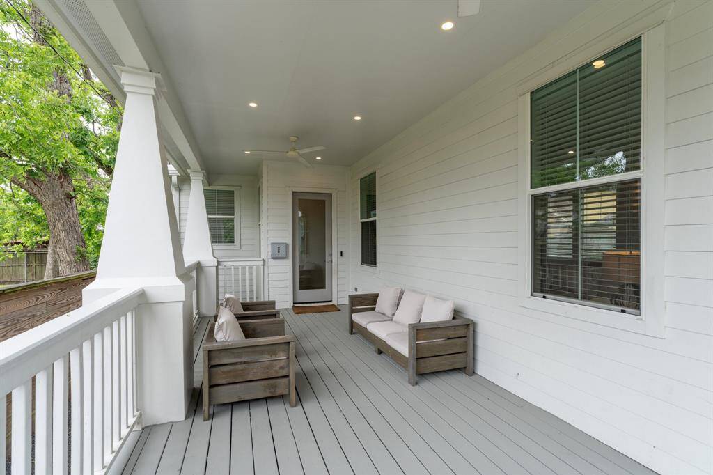 The spacious covered front porch is perfect for lounging and enjoying the neighborhood breeze, with recessed lighting and ceiling fan for comfort day or night.