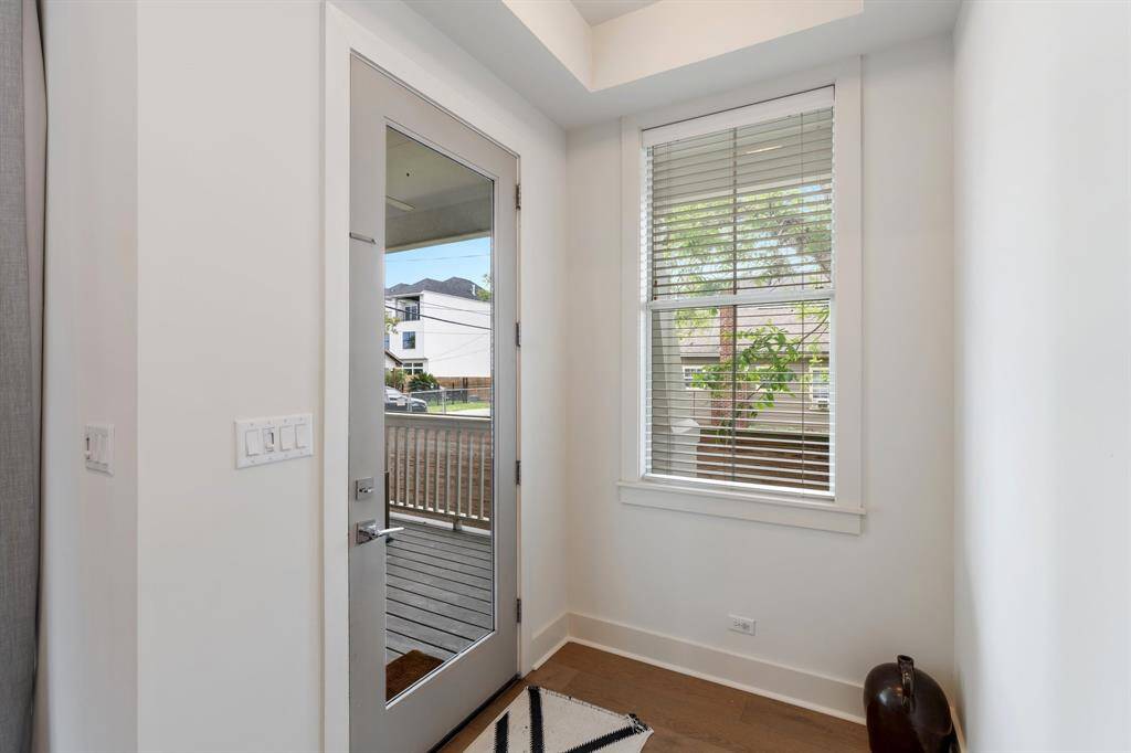 Step inside to a bright and inviting entry, complete with a glass door that allows in natural light while offering a clear view of the welcoming front porch and yard.