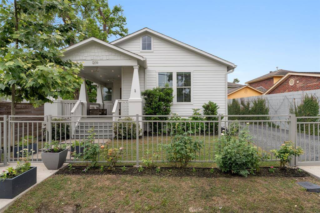 Charming and private, this fully gated home built in 2019 is framed by blooming garden beds and a crisp white facade that makes a lasting impression.