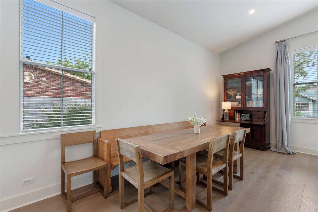 The dedicated dining space sits beside oversized windows, making it bright and welcoming. The area easily accommodates gatherings and offers a natural transition to the kitchen and living room.