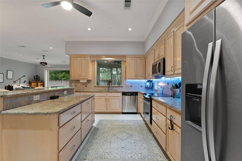 Plenty of Cabinets and Drawer Space for Pot Storage, Notice the Window over the sink that overlooks the Screened in Porch
