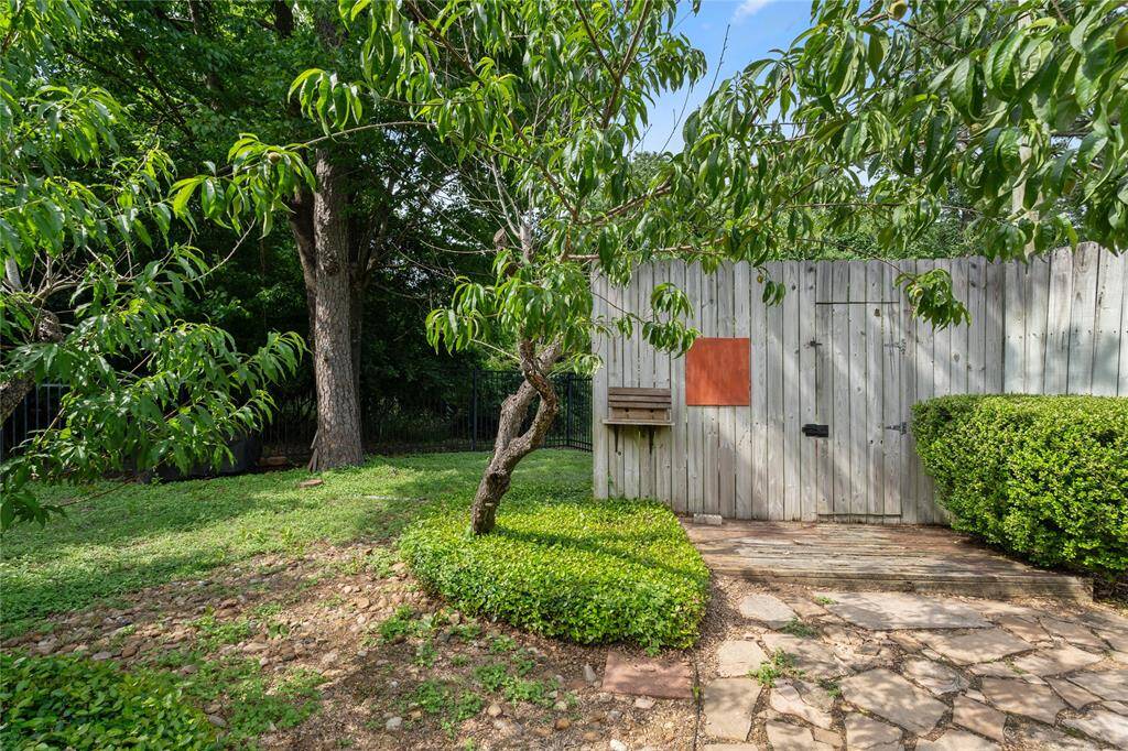Two Fruit Trees Adorn the Back Yard providing Peaches