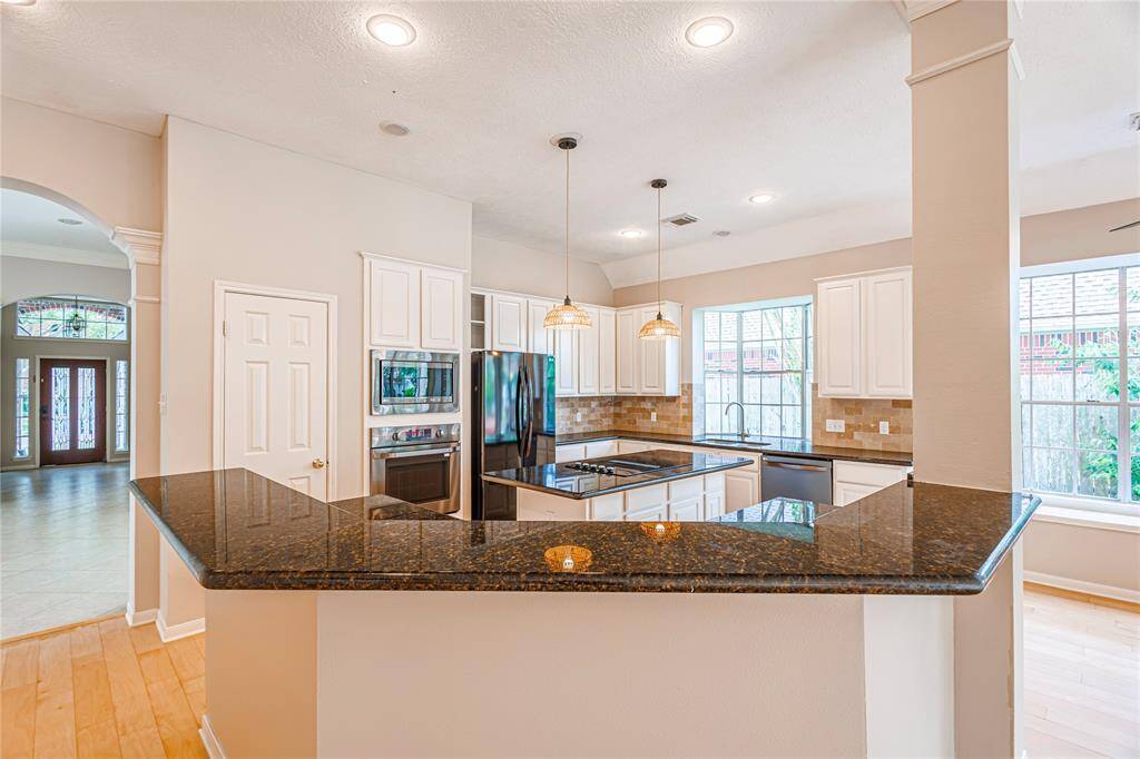 Convenient breakfast bar with granite countertops.