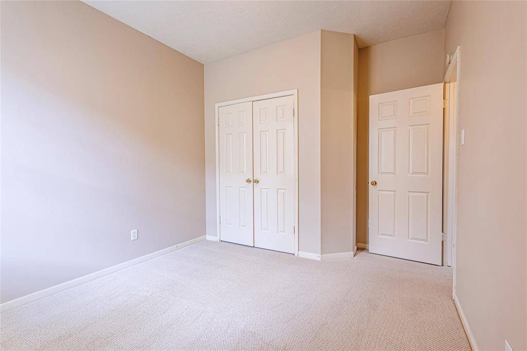 Secondary bedroom with new designer carpets.
