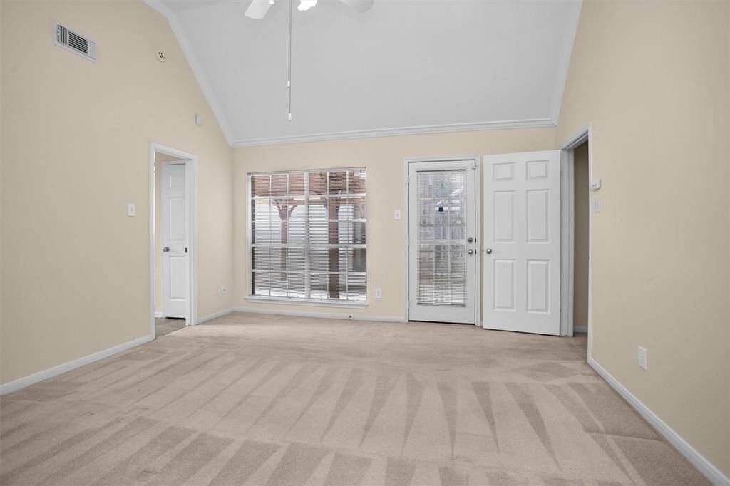 Primary bedroom with door to the back patio