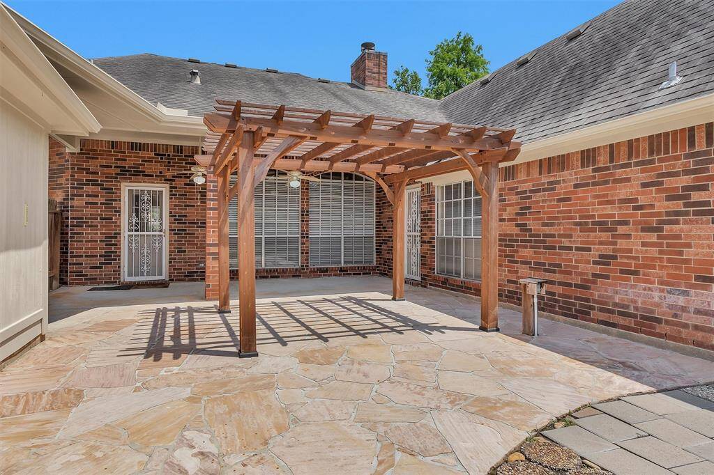Extended back patio betwen the garage and primary bedroom