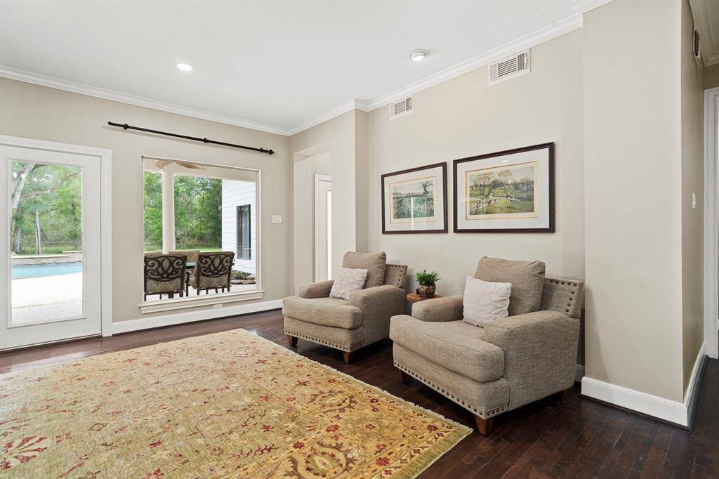 The serene outdoor backdrop creates a seamless connection between indoor comfort and outdoor beauty, making it an ideal setting for entertaining guests or enjoying quiet moments.