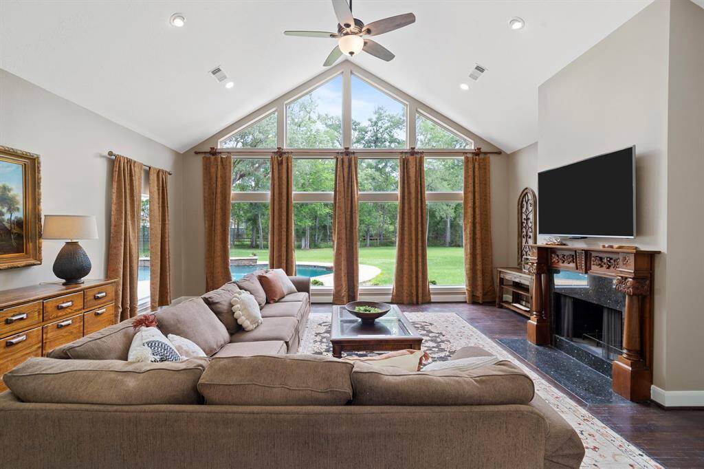 This bright, open landing area features large windows with scenic views and hardwood flooring.