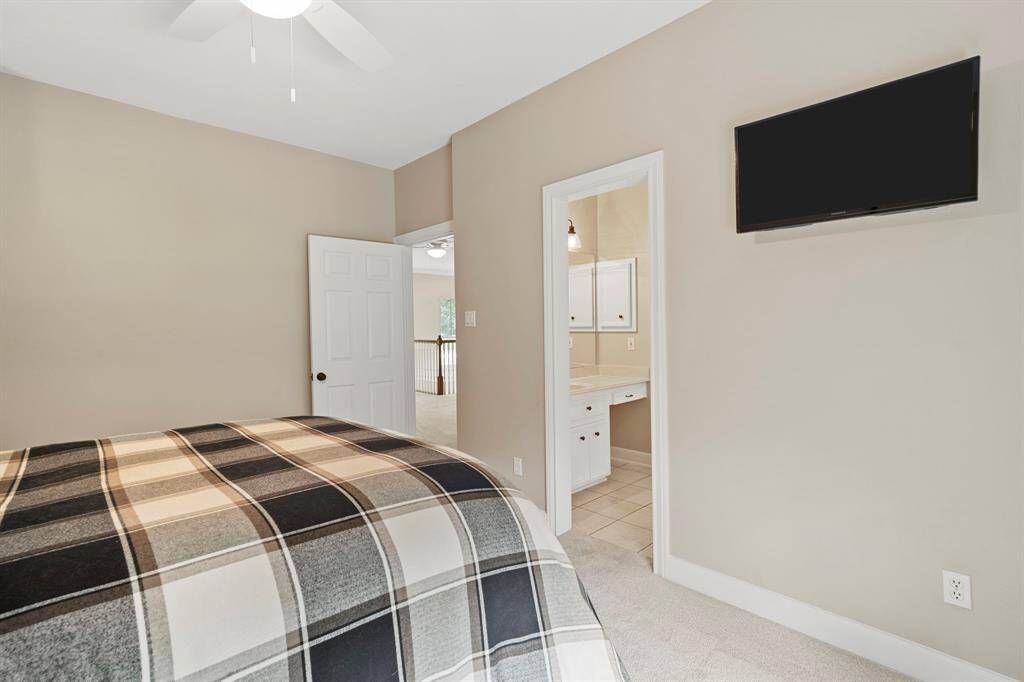 oft carpet underfoot and neutral paint tones create a warm, inviting atmosphere, while the en-suite bath offers both comfort and convenience.