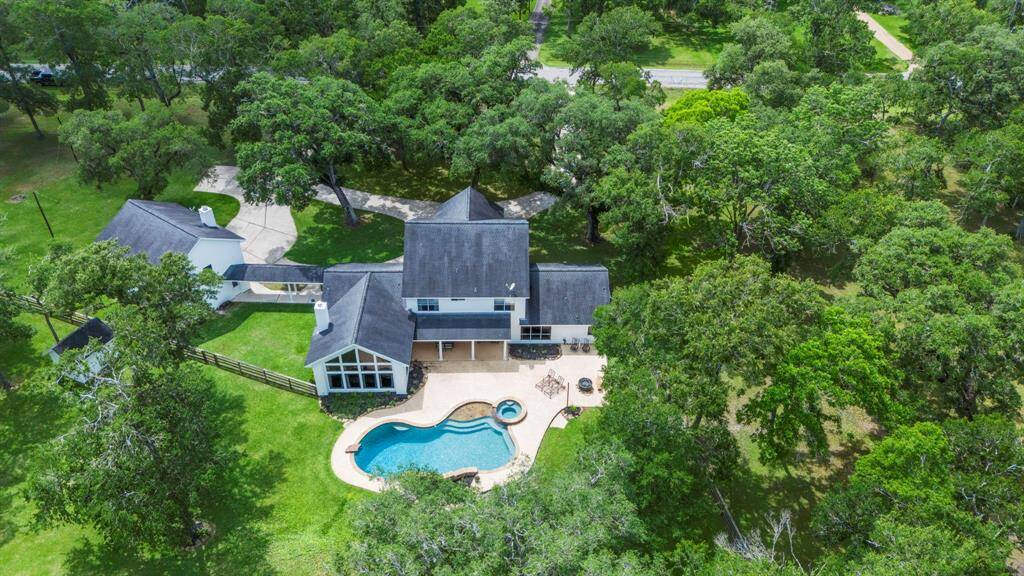 This stunning two-story white Colonial home with stately columns is perfectly positioned on just over 4 acres of lush, green land.