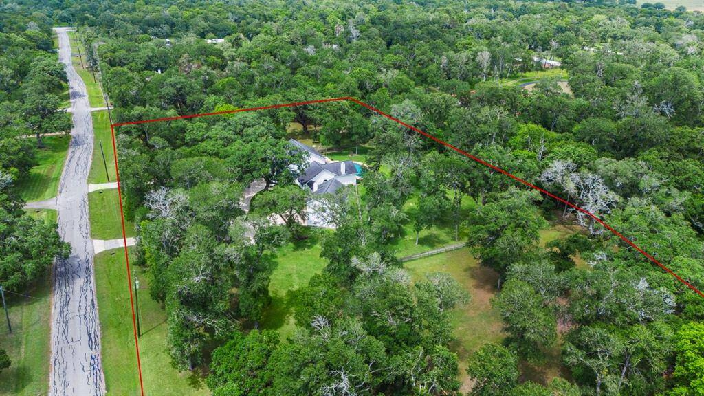 The property’s generous acreage provides endless possibilities for outdoor living, from creating private gardens to enjoying the open green space that surrounds the home.