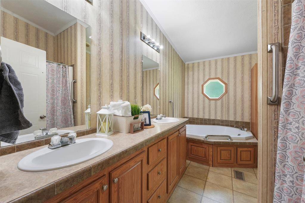 Primary Bathroom with double sinks, soaker tub and stand in shower.
