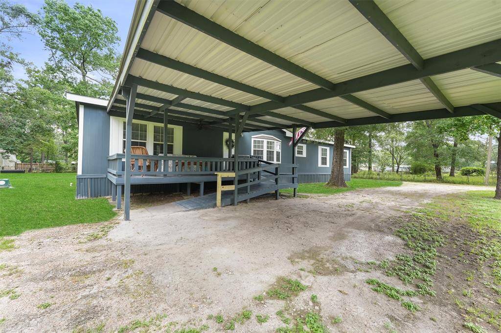 Covered front porch and two car cover. Front entrance has accessible ramp.
