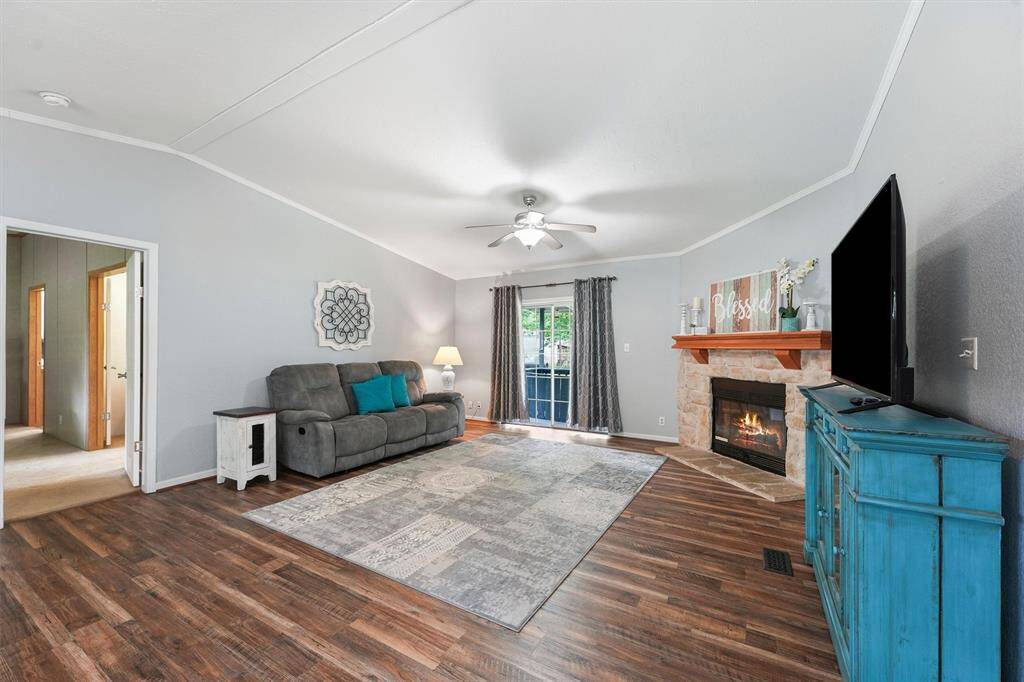 Livingroom and Primary bedroom entrance. Sliding door exits onto a small, covered porch with accessible ramp to the back yard.