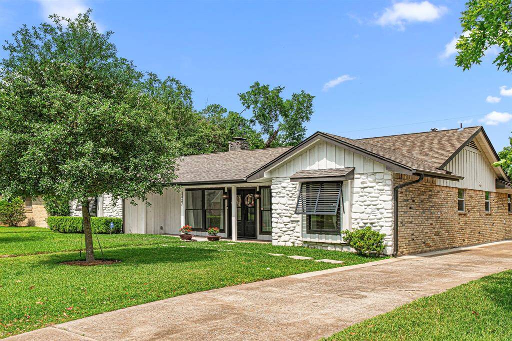 Long driveway leading to a carport at the back of the home.
