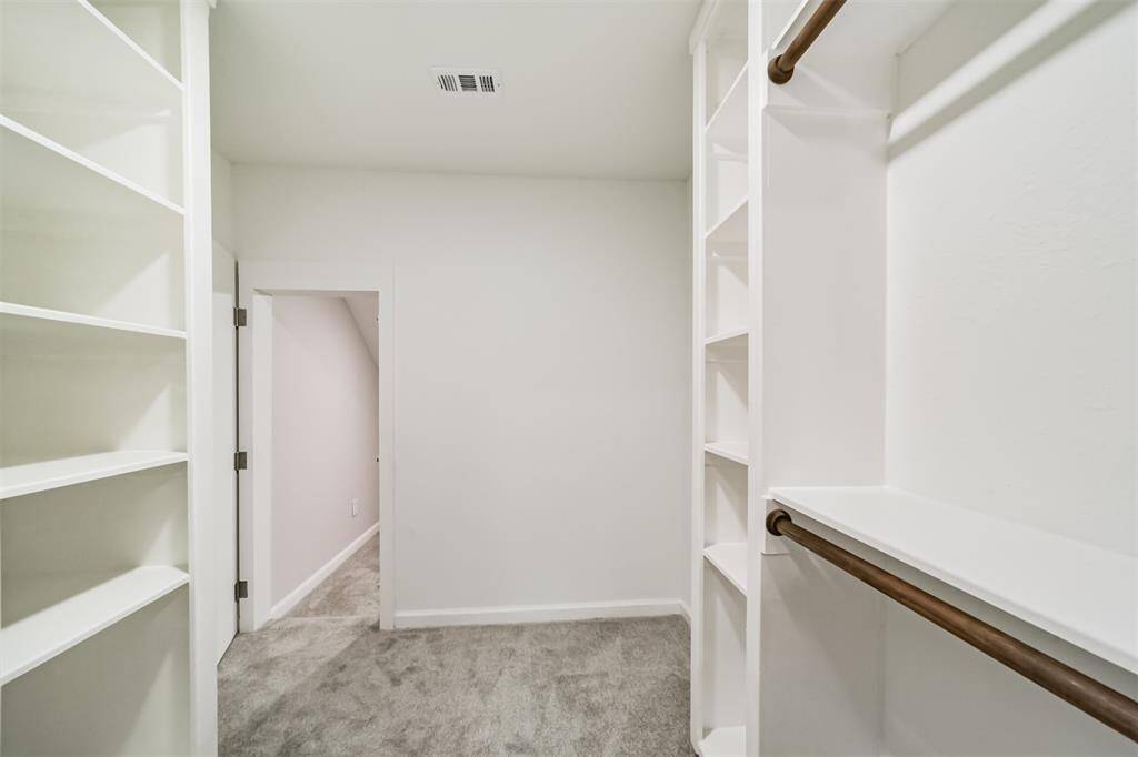 Walk-in closet with climate controlled storage/playroom behind the mirror