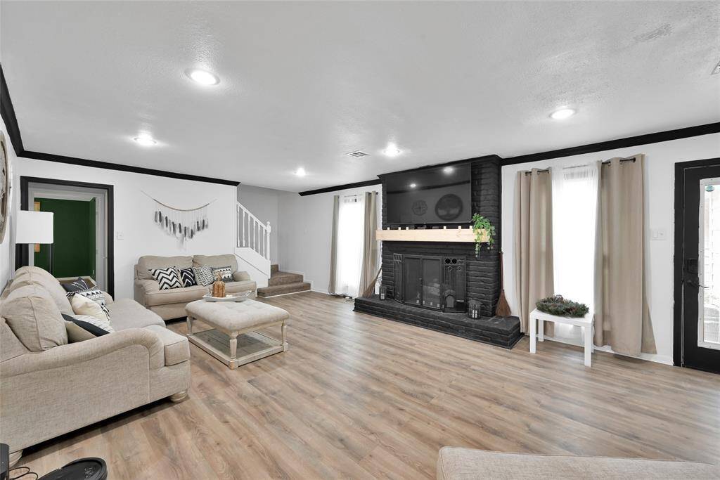 The spacious living room is open to the kitchen area and updated with paint and flooring.