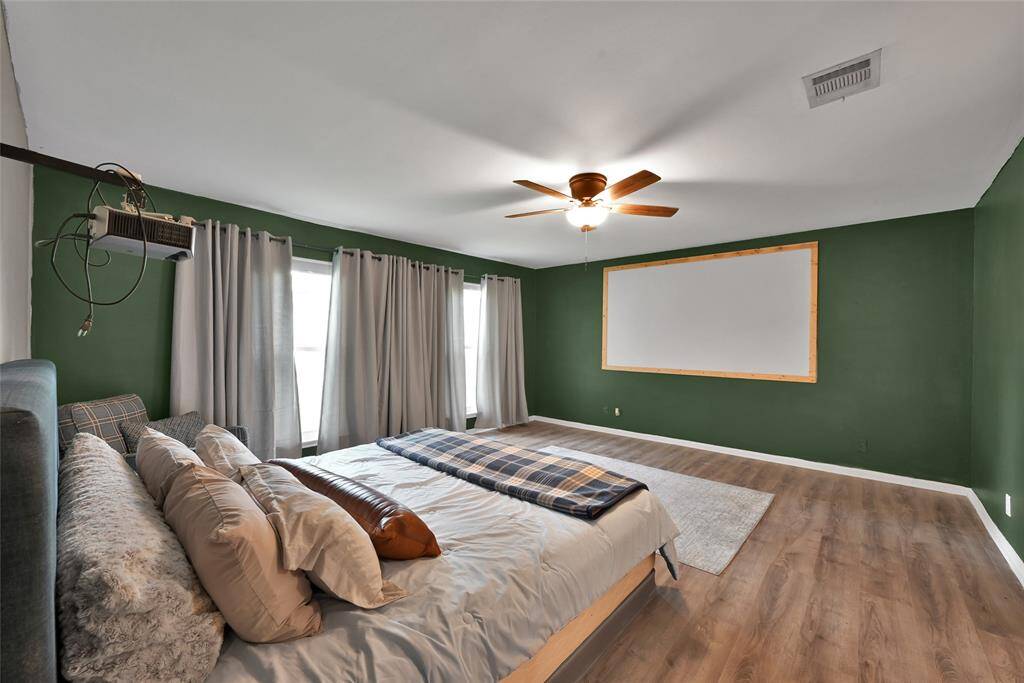 The sizeable primary suite is located downstairs and has new paint plus a wall-mounted projector and screen. The screen can pop off easily if you chose to do so!