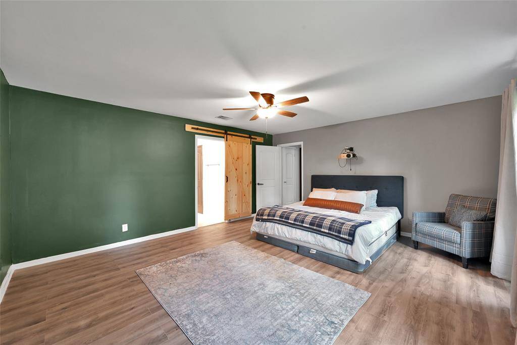Barn door leading to primary bath.