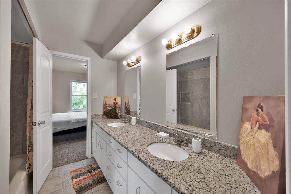 Full bath with dual sinks separating secondary bedroom #1 and secondary bedroom #2