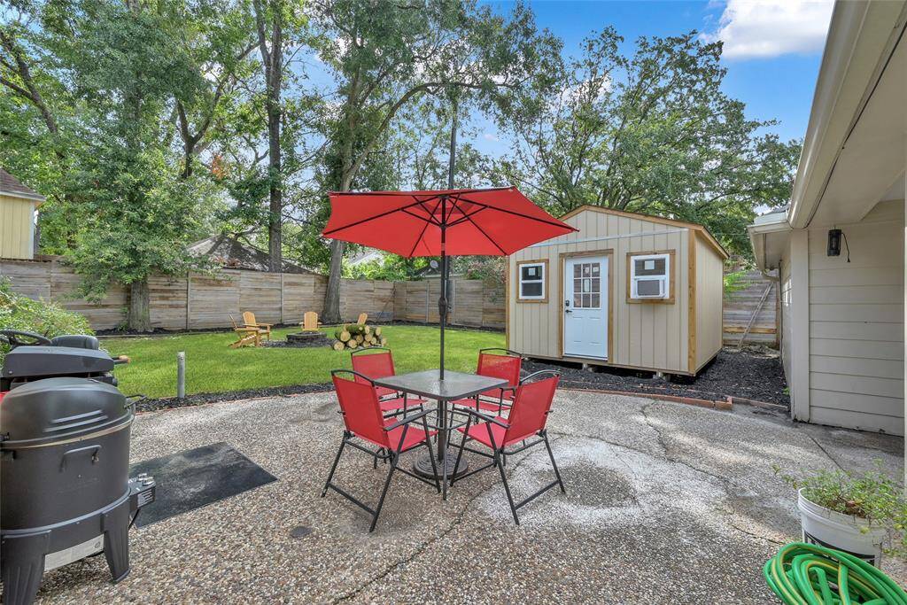 The backyard features a cobblestone patio, high fence line, and a 16x12 shed with AC and Electric capabilities ready to be converted into an amazing space of your choice!
