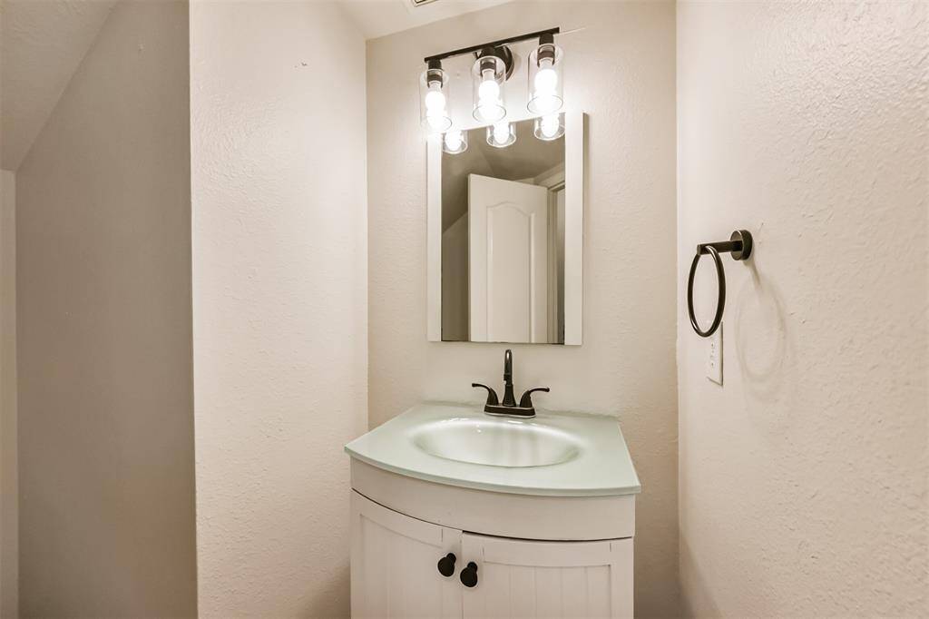 Half Bath downstairs with upgraded Lighting, Sink & toilet.