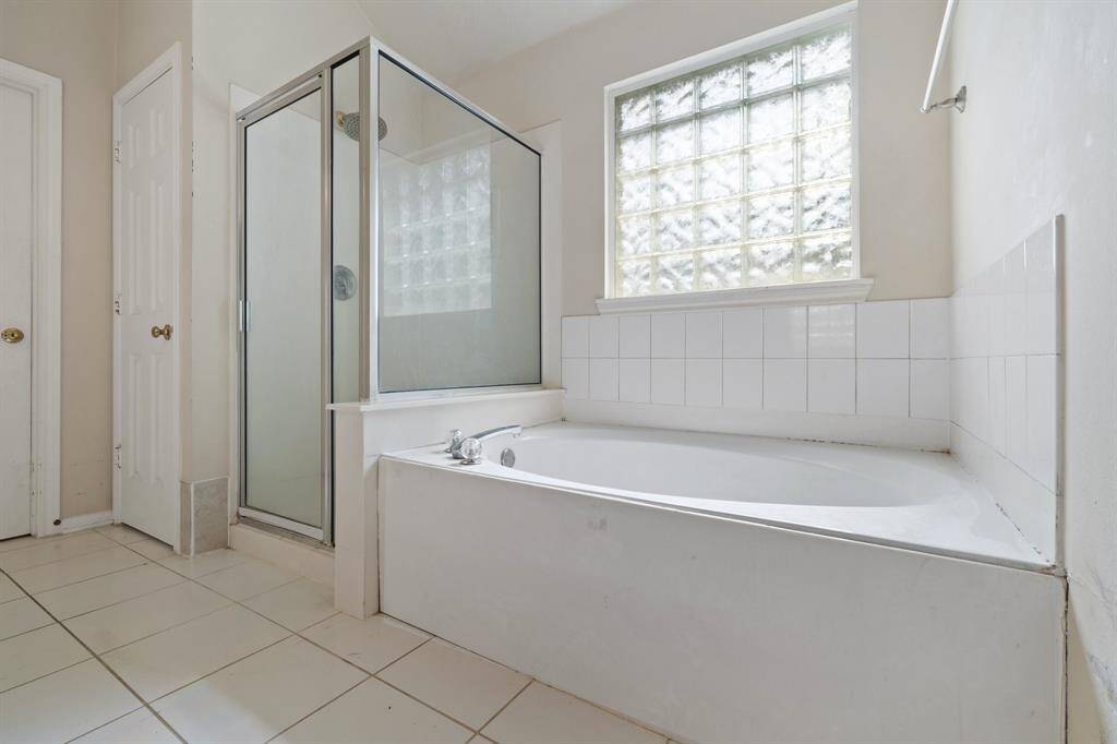 Separate shower and large soaking tub.